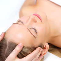 Beautiful woman relaxing with a head massage at the beauty spa